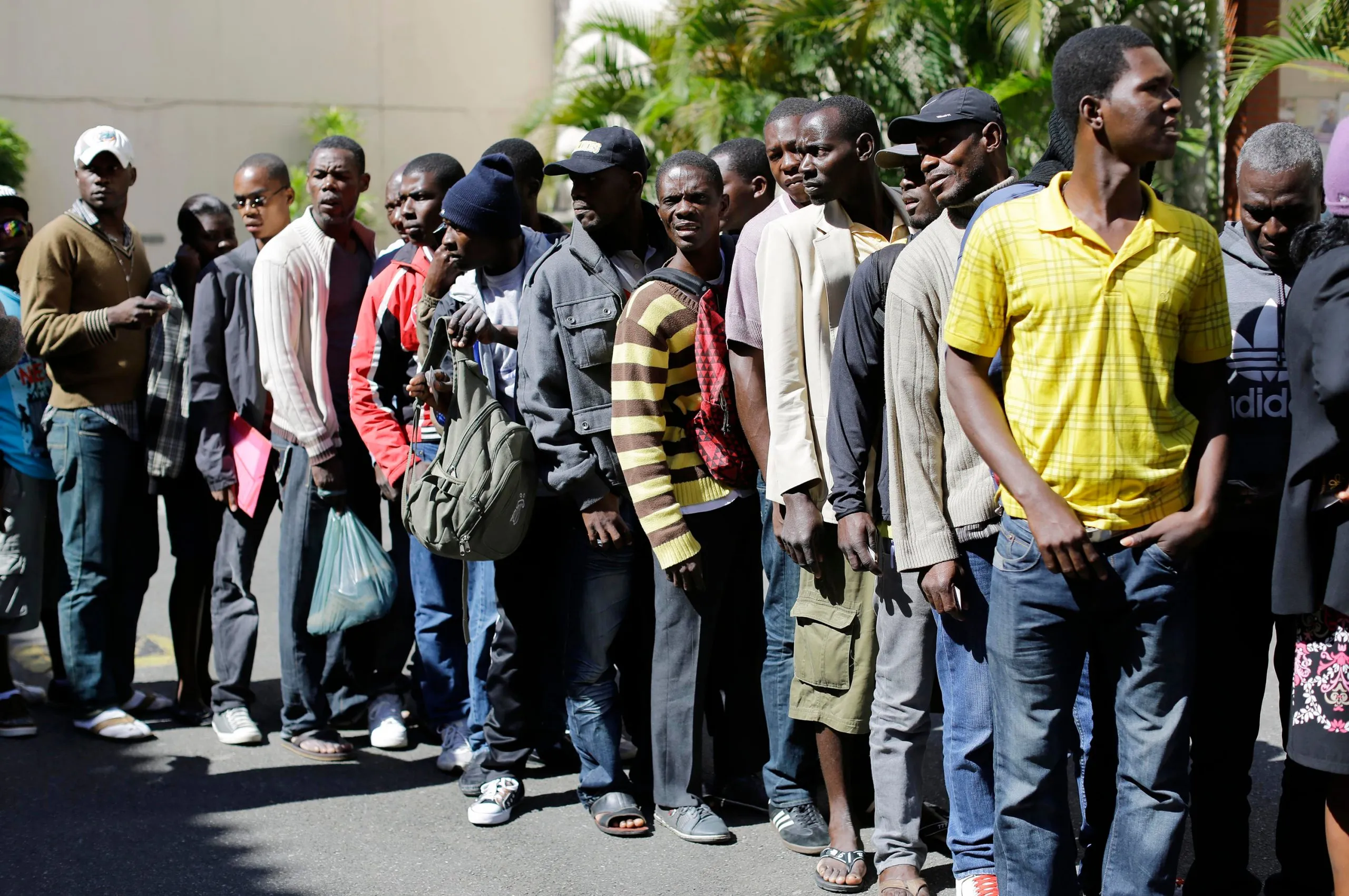 A group of African migrants in a queue