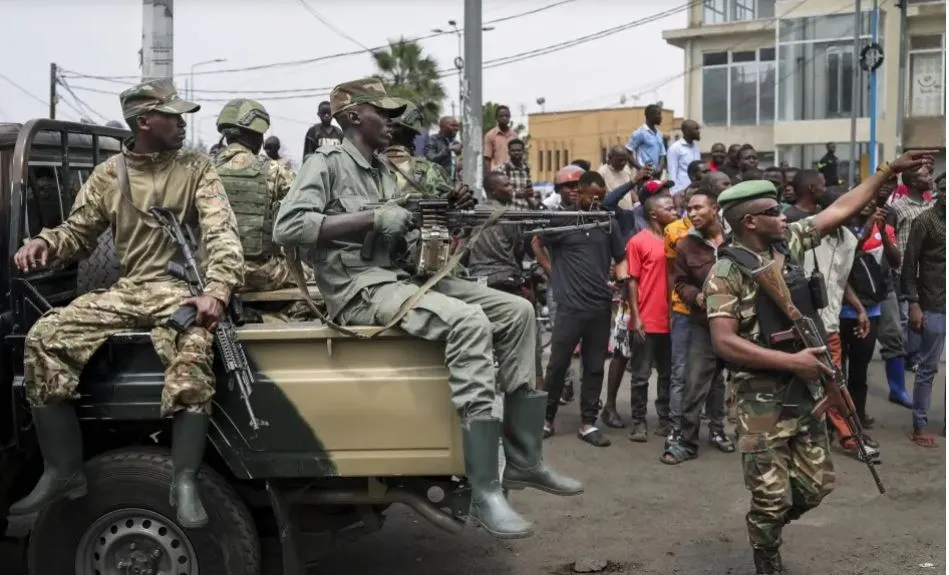M23 troops brandishing weapons in an operation vehicle.