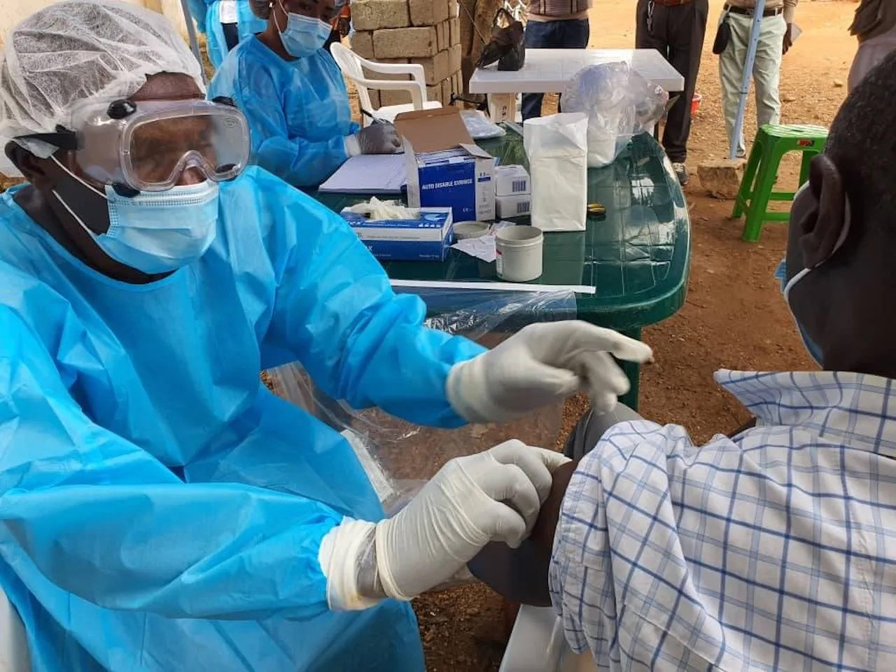 Health official administering a vaccine.